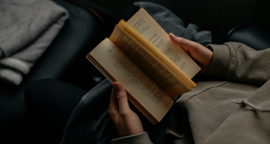 the act of holding a book, flipping through the pages at random, and reading only the pages that happen to open.